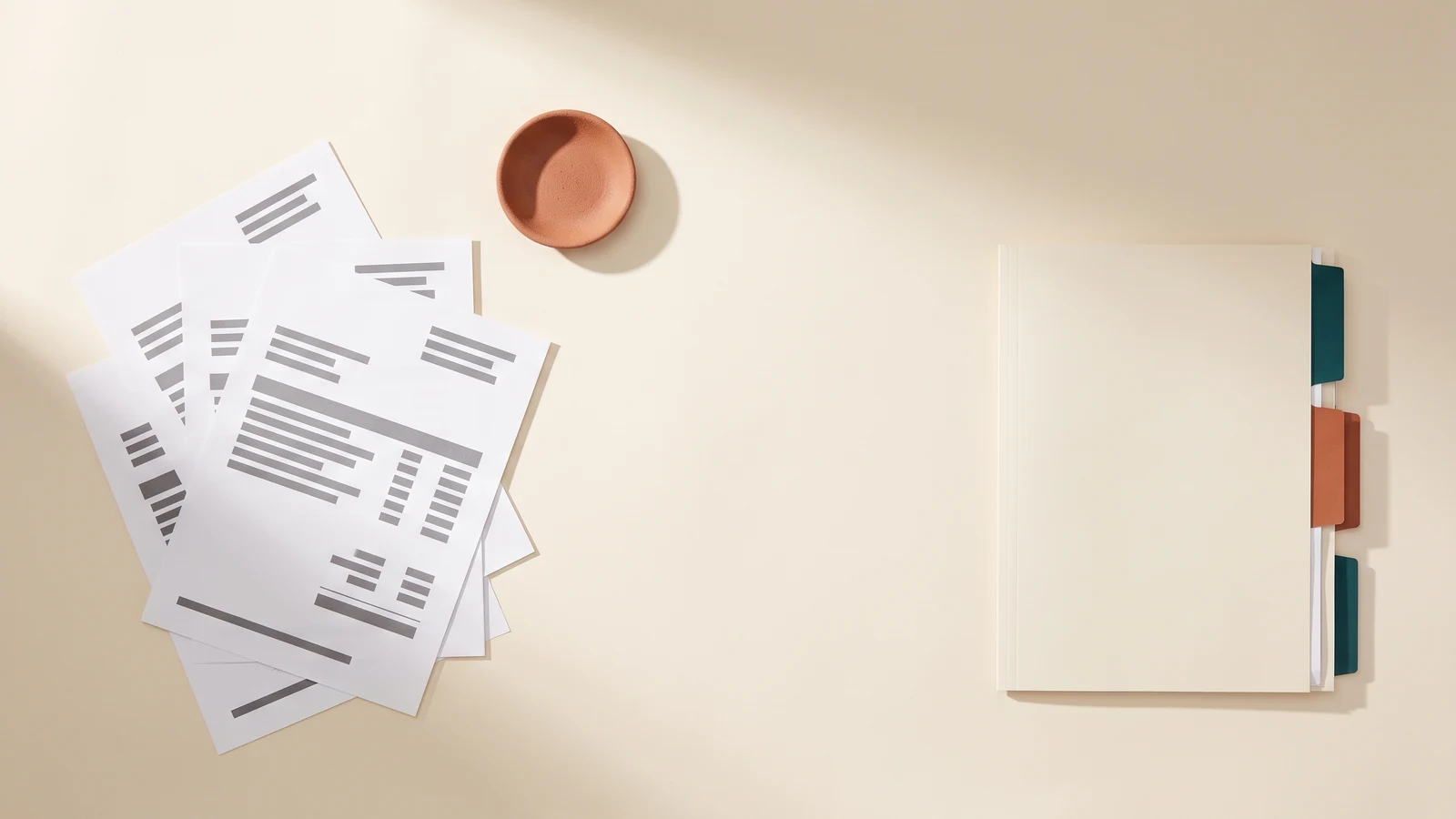 Prepared documents and a tabbed folder laid out on a desk